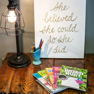 a lamp, books, and a sign on a table