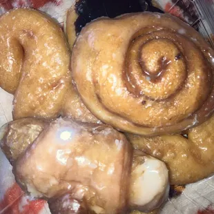 a variety of doughnuts in a plastic container