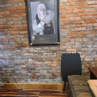 a portrait of a woman on a brick wall