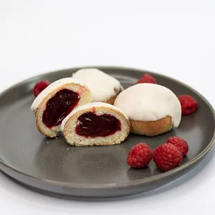 raspberry filled doughnuts on a plate