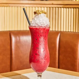 a red drink with ice and a straw