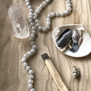 Custom Mala beads, quartz crystals and Palo Santo.