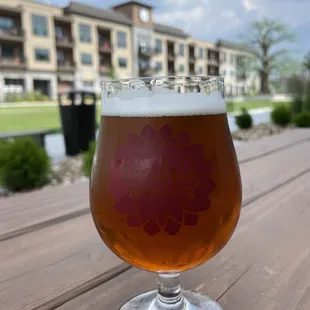 a glass of beer on a wooden table