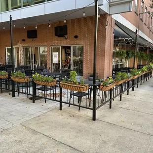 a patio with tables and chairs