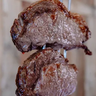 two steaks on a fork