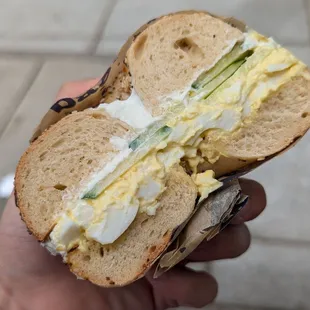 Egg salad and cucumber on everything bagel