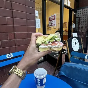 Egg bagel with cream cheese, tomato, red onion, cucumber, daikon sprouts, and avocado. With a jasmine green tea