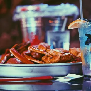 a plate of crab legs and a drink