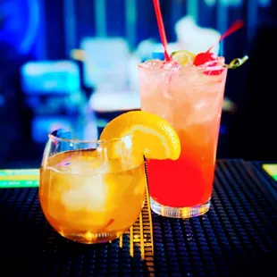two cocktails on a bar