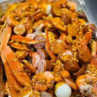 a tray of cooked crabs and corn