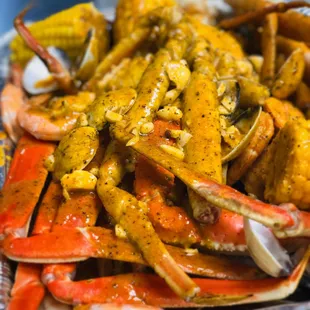 a plate of crab legs and corn on the cob