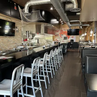 a long bar with white chairs