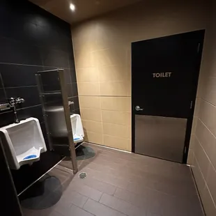 two urinals in a public restroom