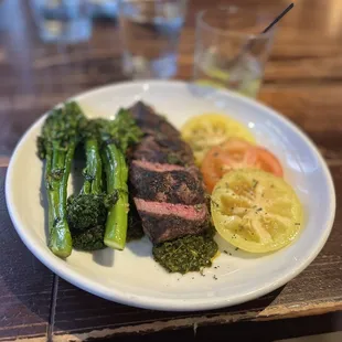 Flank steak w bomb chimichurri sauce, broccolini, and fresh tomatoes