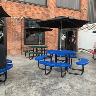 a man sitting at a blue picnic table