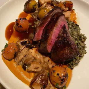 Wagyu sirloin steak, wild rice, sweet potato purée, braised mushrooms, blistered cherry tomatoes