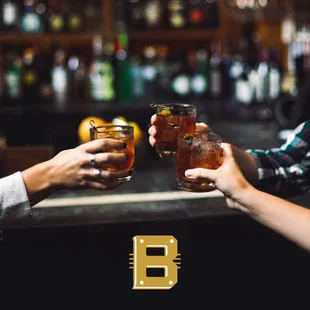 two people clinking glasses of beer