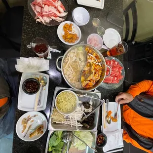 Hot pot with a miso broth and a Szechuan broth. Brisket pork belly veggie platter, noodles, etc. so good