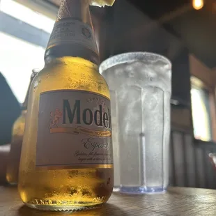 a bottle of modell beer and a glass of water