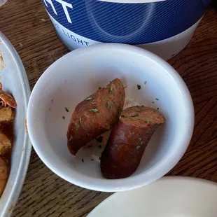 extra sausage, brought out after we complained about the two slivers of sausage. (Eaten, not pictured, but we're much smaller in comparison)
