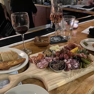 a platter of meats, cheeses, and breads