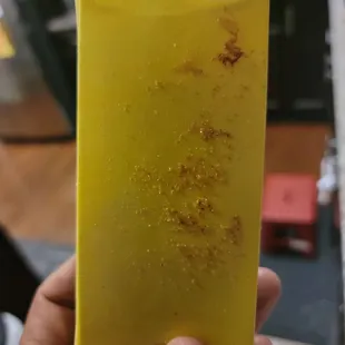 a hand holding a piece of yellow soap