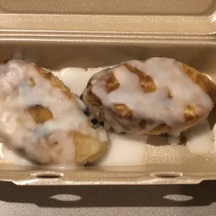 two pastries in a styrofoam container