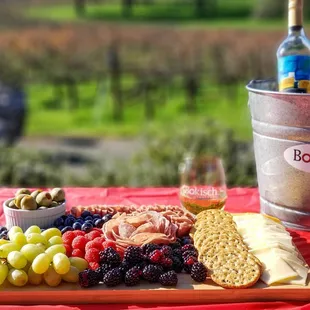 a platter of cheese, grapes, and bread