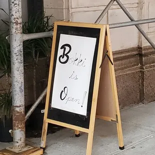 a sign on a sidewalk