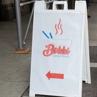 a sign on a sidewalk