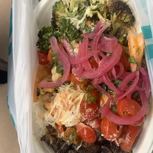Shrimp with jasmine rice, pickled onions, tomatoes, mushrooms, broccoli and Parmesan cheese