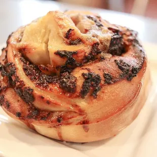 a closeup of a bun with a scoop of ice cream on top