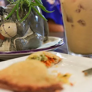 a plate of food and a glass of iced coffee