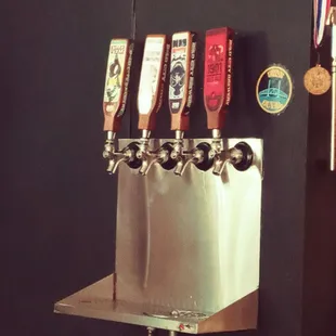 a row of beer taps on a wall