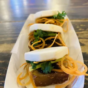 two buns filled with meat and veggies