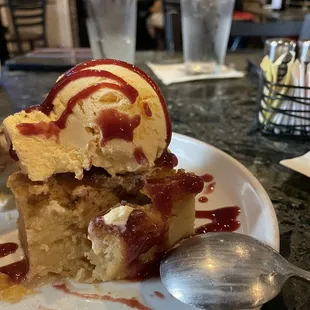 a piece of cake on a plate with a scoop of ice cream