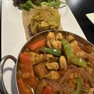 Chicken tibs with tiqel gomen.