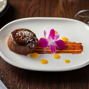 a dessert on a plate with a flower