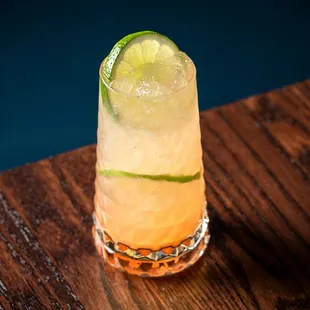 a cocktail with a slice of lime on the rim