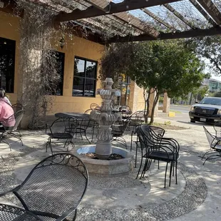 a patio with tables and chairs