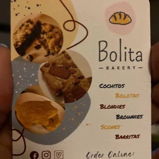 a hand holding a business card