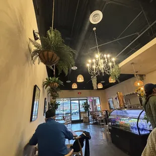 two people sitting at tables in a coffee shop