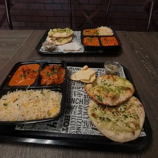 2 Thali plates both with Tikka masala and butter chicken. One side order os garlic naan.
