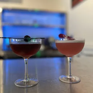 two cocktails on a bar