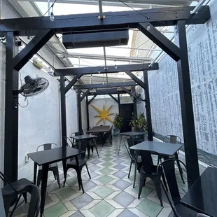 a patio area with tables and chairs