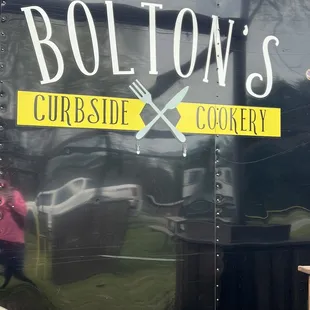 a woman standing in front of a food truck
