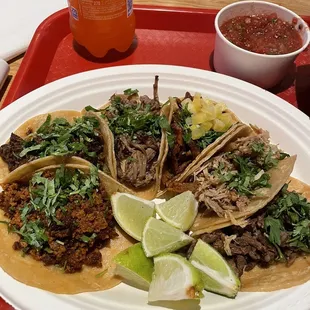 a plate of tacos and a drink
