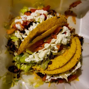 Crispy beef tacos (optional sour cream packet applied)