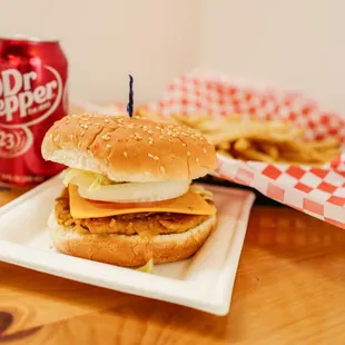 a burger and a soda on a table