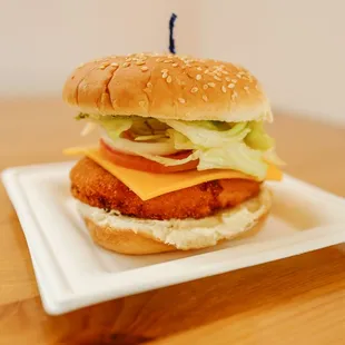 a chicken burger with lettuce, tomato, and cheese